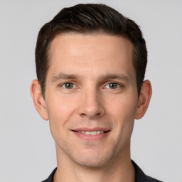 Joyful white young-adult male with short  brown hair and grey eyes