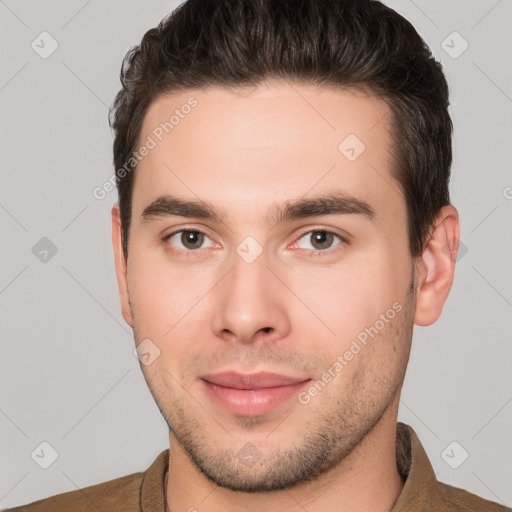 Joyful white young-adult male with short  brown hair and brown eyes