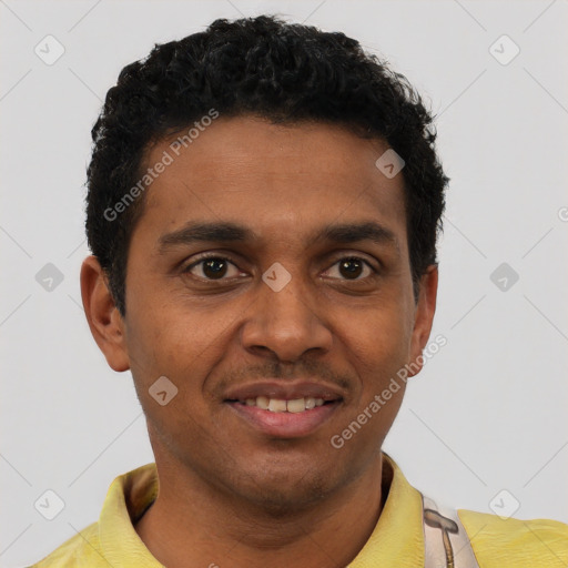 Joyful black young-adult male with short  brown hair and brown eyes