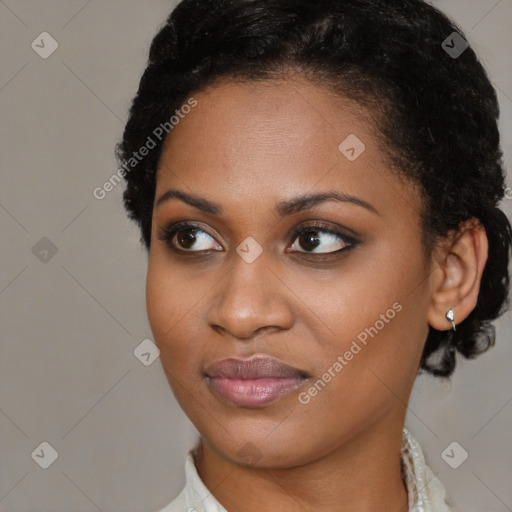 Joyful black young-adult female with short  brown hair and brown eyes