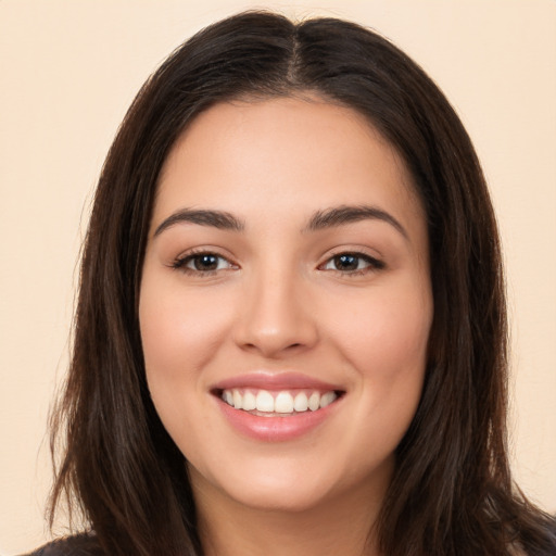 Joyful white young-adult female with long  brown hair and brown eyes