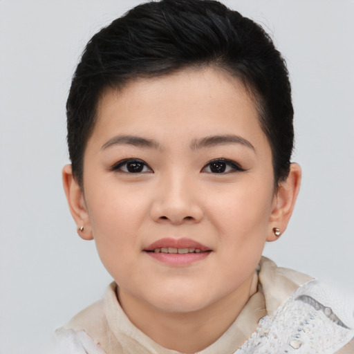 Joyful asian child female with short  brown hair and brown eyes
