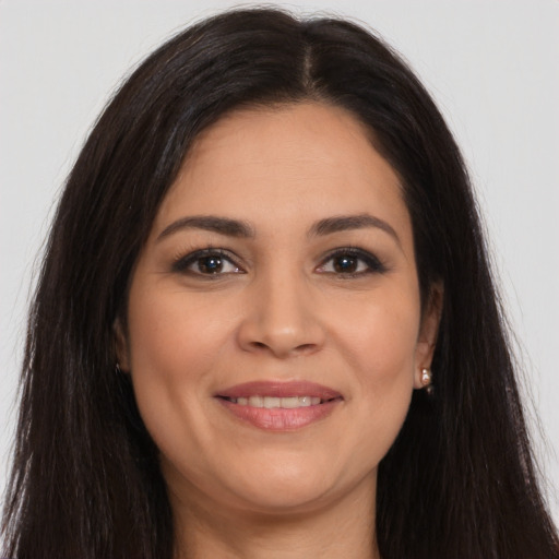 Joyful latino young-adult female with long  brown hair and brown eyes