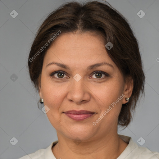 Joyful white adult female with medium  brown hair and brown eyes