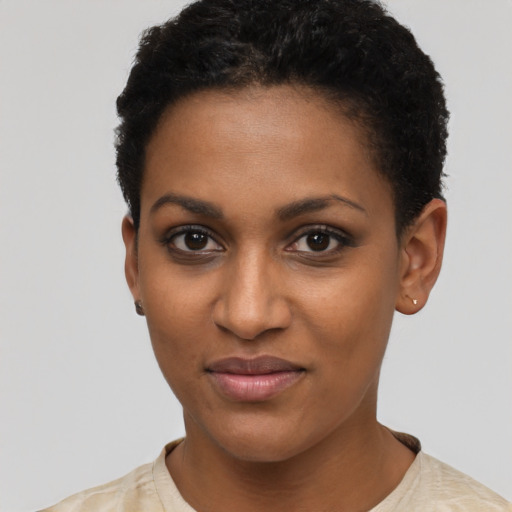 Joyful black young-adult female with short  black hair and brown eyes