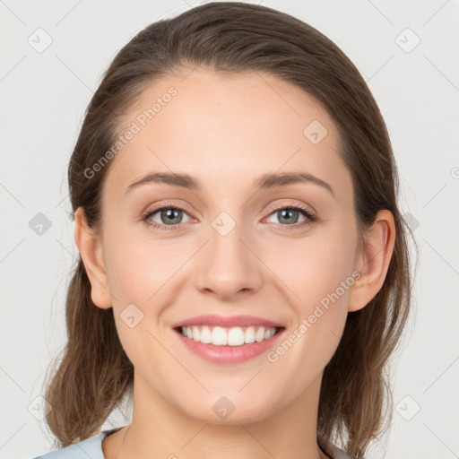 Joyful white young-adult female with long  brown hair and grey eyes