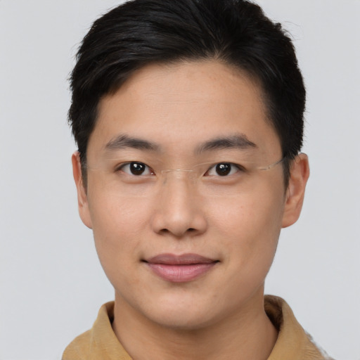 Joyful asian young-adult male with short  brown hair and brown eyes