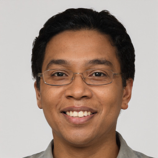Joyful latino adult male with short  black hair and brown eyes