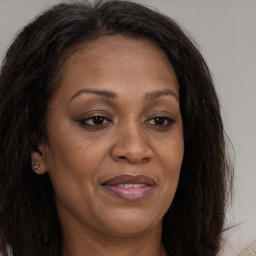 Joyful white adult female with long  brown hair and brown eyes