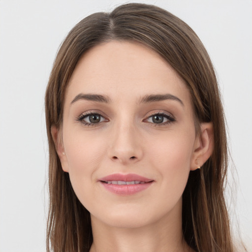 Joyful white young-adult female with long  brown hair and grey eyes