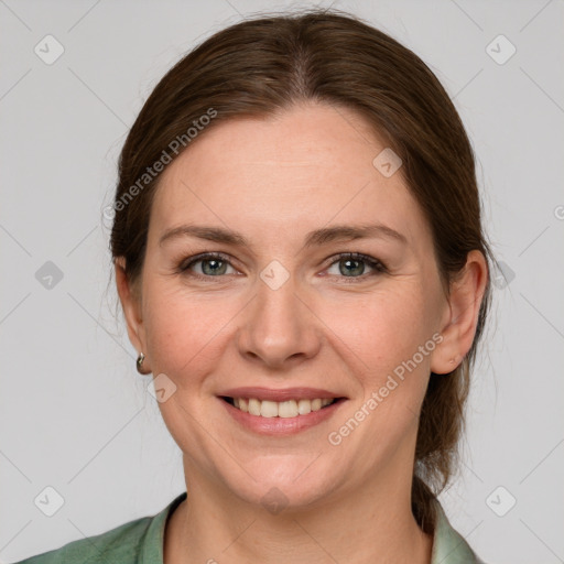 Joyful white young-adult female with medium  brown hair and grey eyes