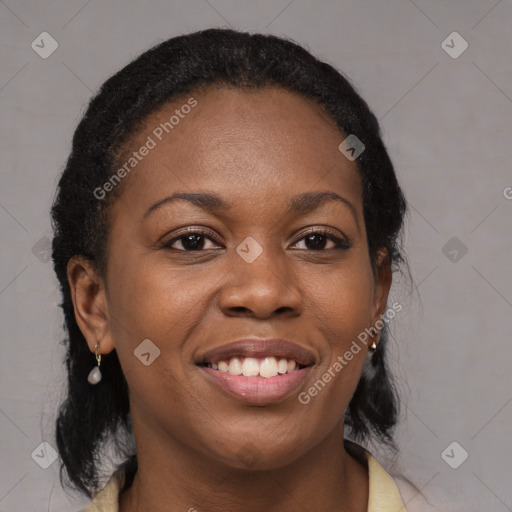 Joyful black young-adult female with medium  black hair and brown eyes