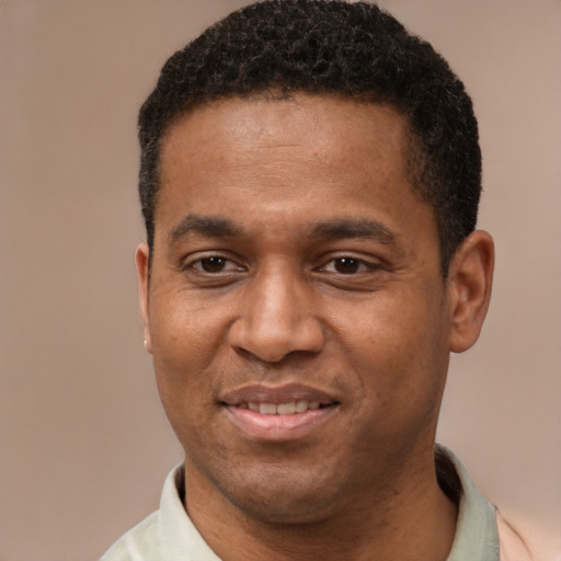 Joyful latino young-adult male with short  brown hair and brown eyes