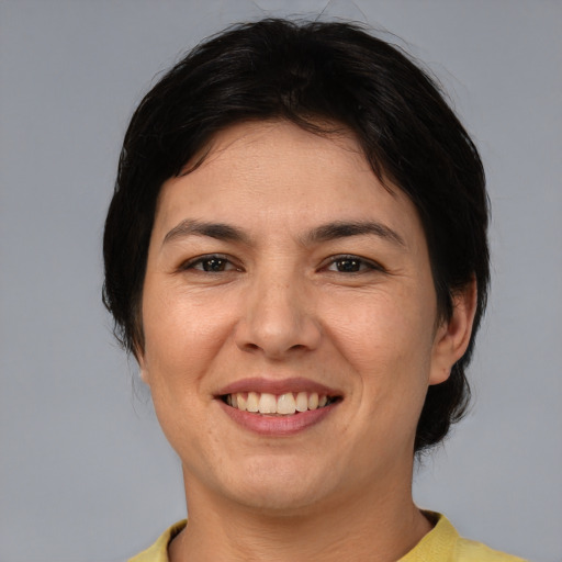 Joyful asian adult female with short  brown hair and brown eyes