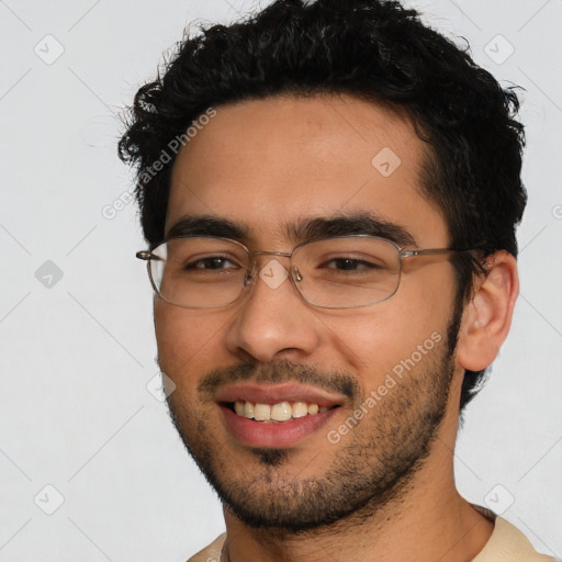 Joyful latino young-adult male with short  black hair and brown eyes