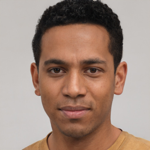 Joyful latino young-adult male with short  black hair and brown eyes