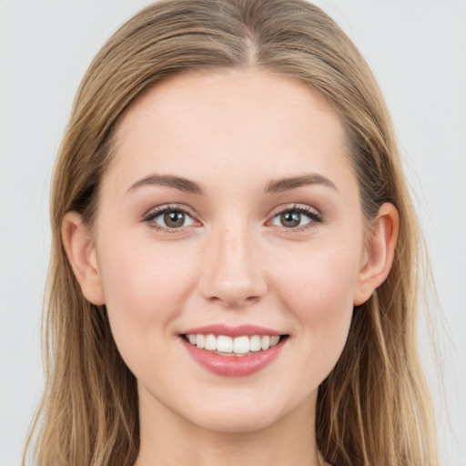 Joyful white young-adult female with long  brown hair and grey eyes