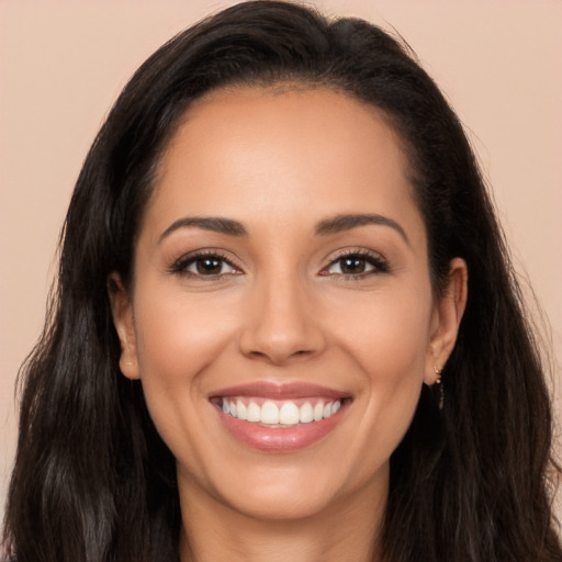 Joyful latino young-adult female with long  brown hair and brown eyes