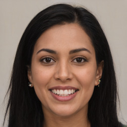 Joyful latino young-adult female with long  brown hair and brown eyes