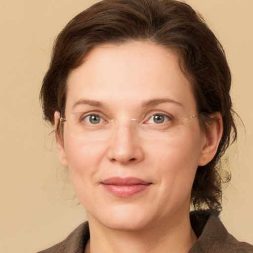 Joyful white adult female with medium  brown hair and grey eyes