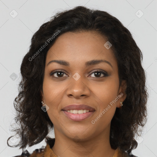 Joyful black young-adult female with long  brown hair and brown eyes