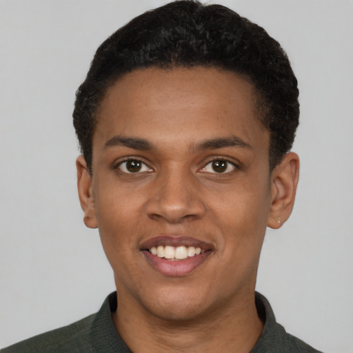 Joyful black young-adult female with short  black hair and brown eyes