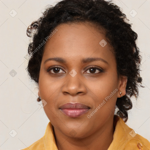 Joyful black young-adult female with long  brown hair and brown eyes