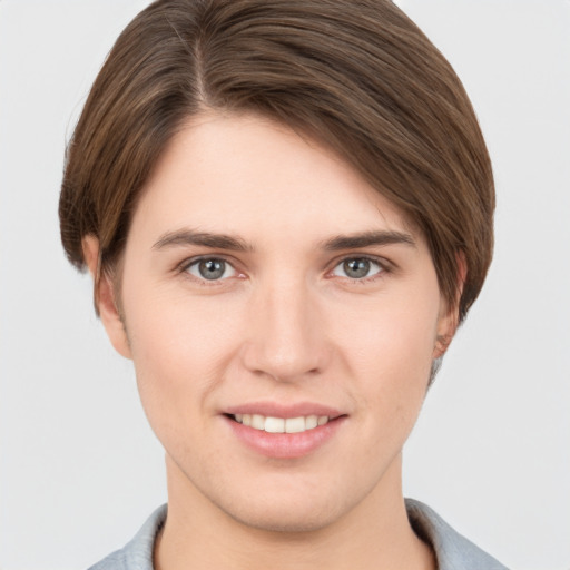 Joyful white young-adult female with short  brown hair and grey eyes