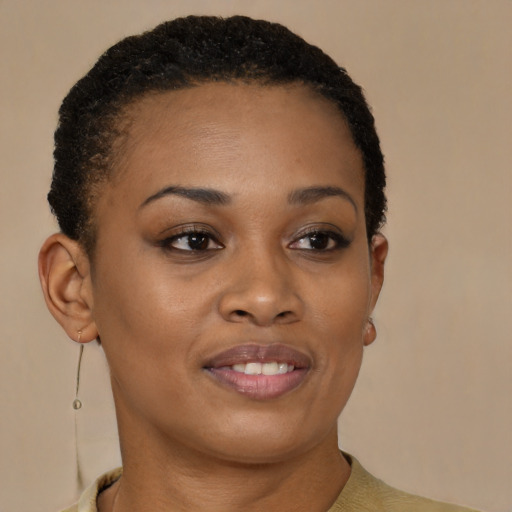Joyful black young-adult female with short  brown hair and brown eyes