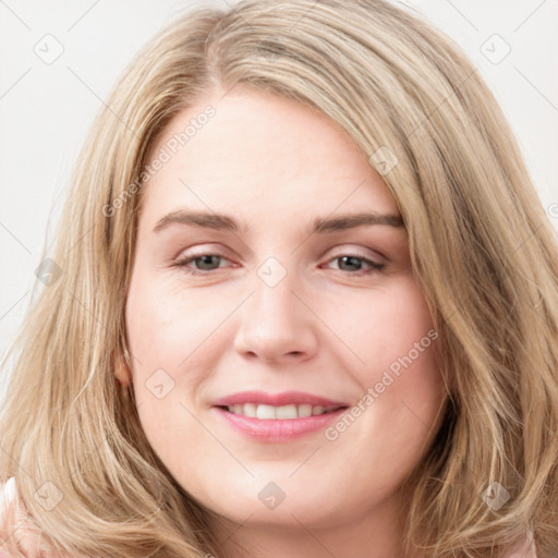 Joyful white young-adult female with long  brown hair and blue eyes