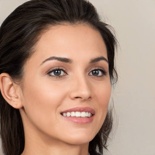 Joyful white young-adult female with medium  brown hair and brown eyes