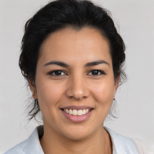 Joyful latino young-adult female with medium  brown hair and brown eyes