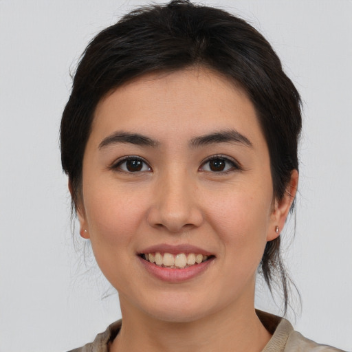 Joyful white young-adult female with medium  brown hair and brown eyes