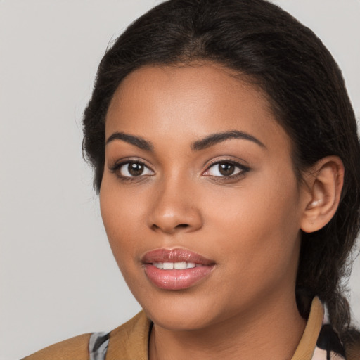 Joyful latino young-adult female with medium  brown hair and brown eyes