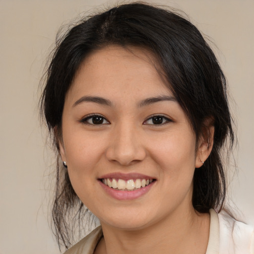 Joyful white young-adult female with medium  brown hair and brown eyes