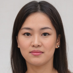 Joyful asian young-adult female with long  brown hair and brown eyes