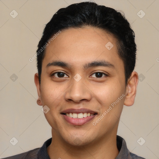 Joyful latino young-adult male with short  black hair and brown eyes