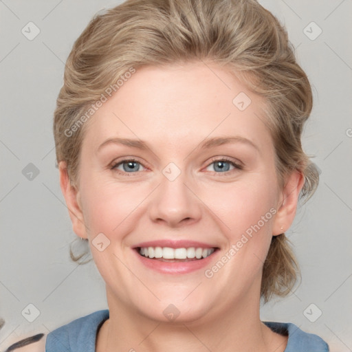 Joyful white young-adult female with medium  brown hair and blue eyes