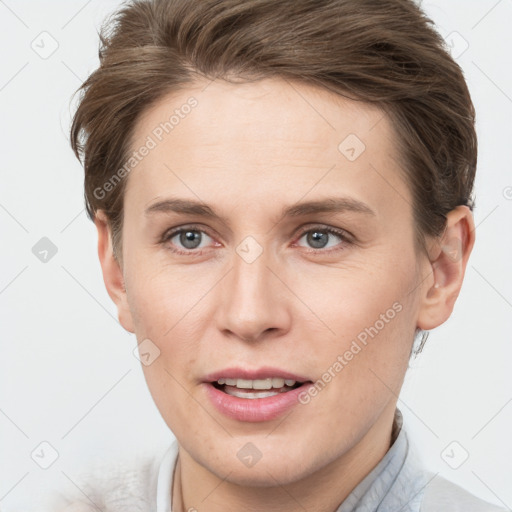 Joyful white young-adult female with short  brown hair and grey eyes