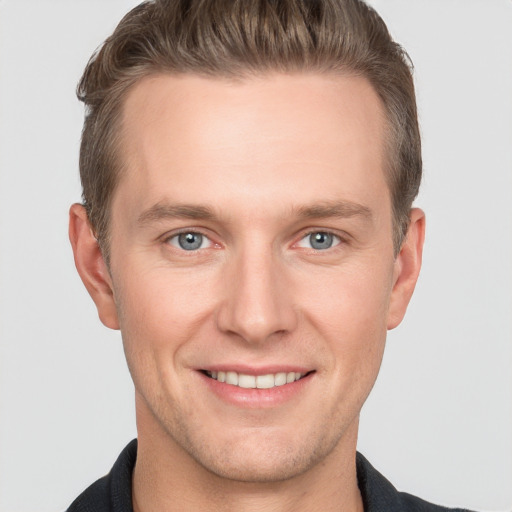 Joyful white adult male with short  brown hair and grey eyes