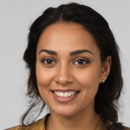 Joyful latino young-adult female with medium  brown hair and brown eyes