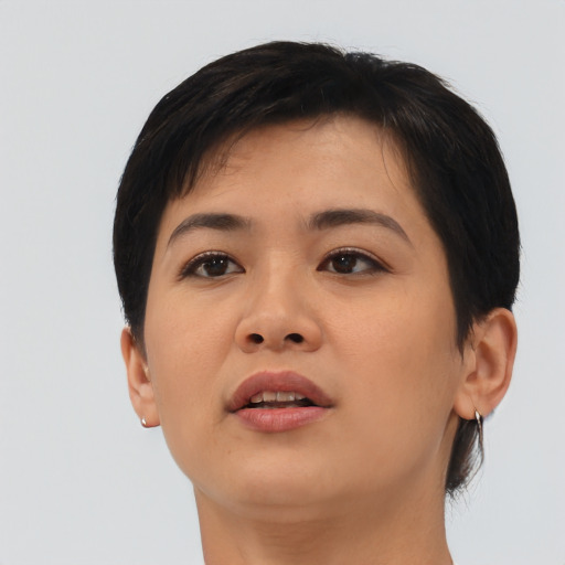 Joyful asian young-adult female with short  brown hair and brown eyes