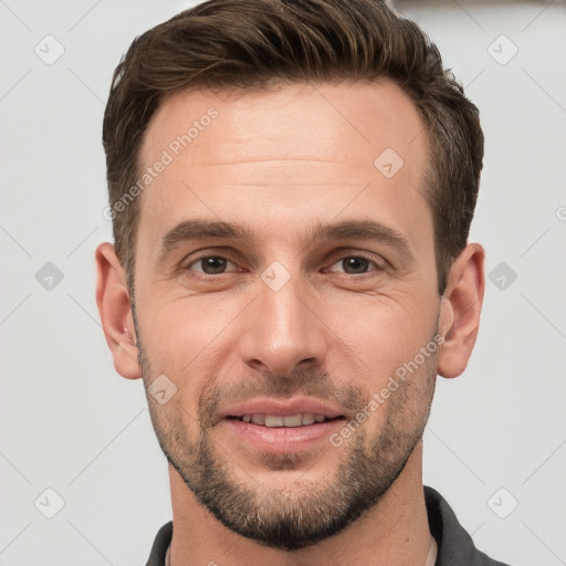 Joyful white young-adult male with short  brown hair and grey eyes