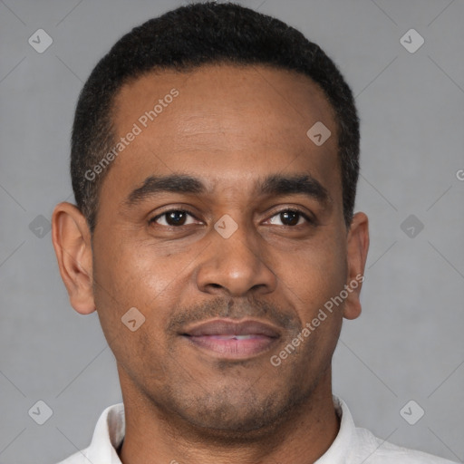 Joyful latino young-adult male with short  brown hair and brown eyes