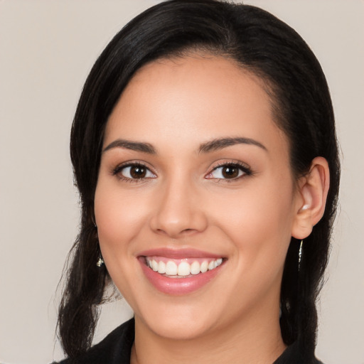 Joyful white young-adult female with long  black hair and brown eyes