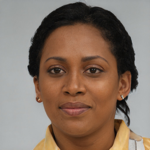 Joyful black young-adult female with short  brown hair and brown eyes