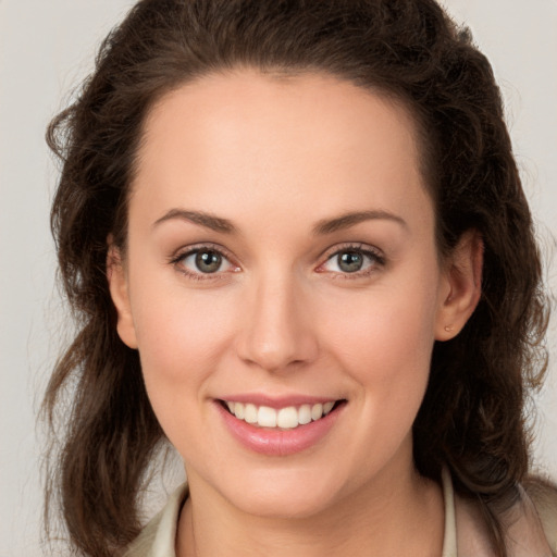 Joyful white young-adult female with long  brown hair and green eyes