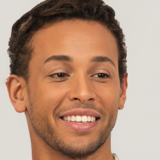 Joyful latino young-adult male with short  brown hair and brown eyes