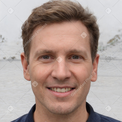 Joyful white adult male with short  brown hair and grey eyes