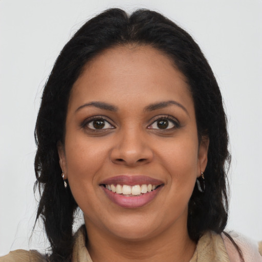 Joyful latino young-adult female with long  brown hair and brown eyes